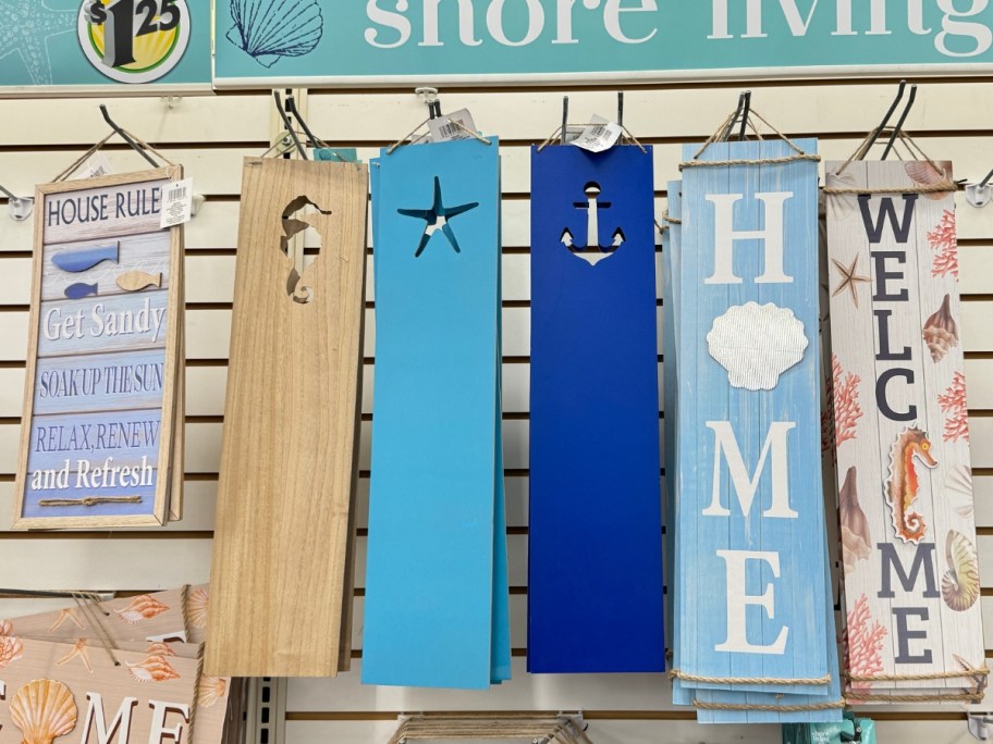 various wall decor beach coastal themed signs on wall display at dollar tree