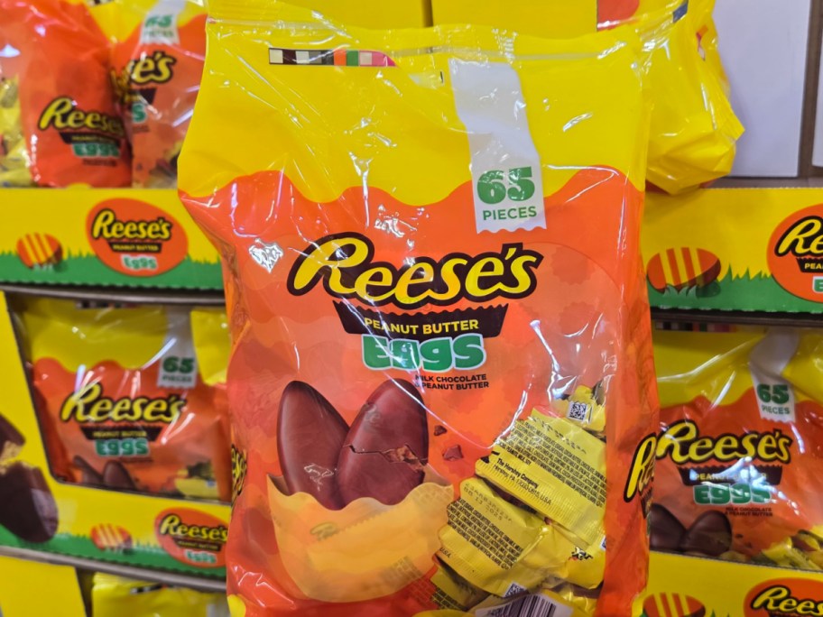 Hand holding REESE'S Milk Chocolate Peanut Butter Eggs 65 Pieces Easter Candy