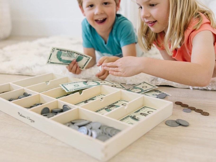 Kid playing with melissa & Doug money