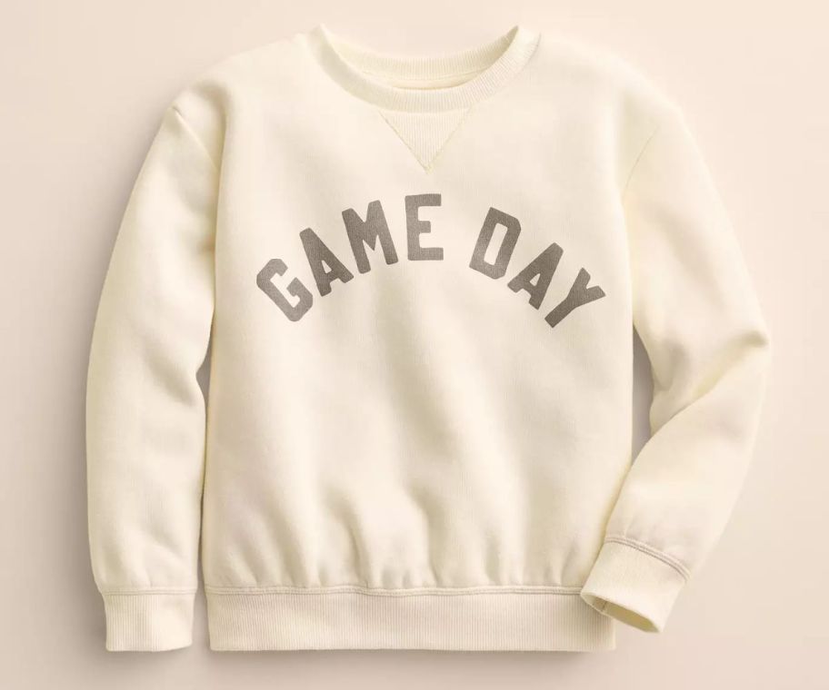 an ivory colored kids sweatshirt with the words game day across the front