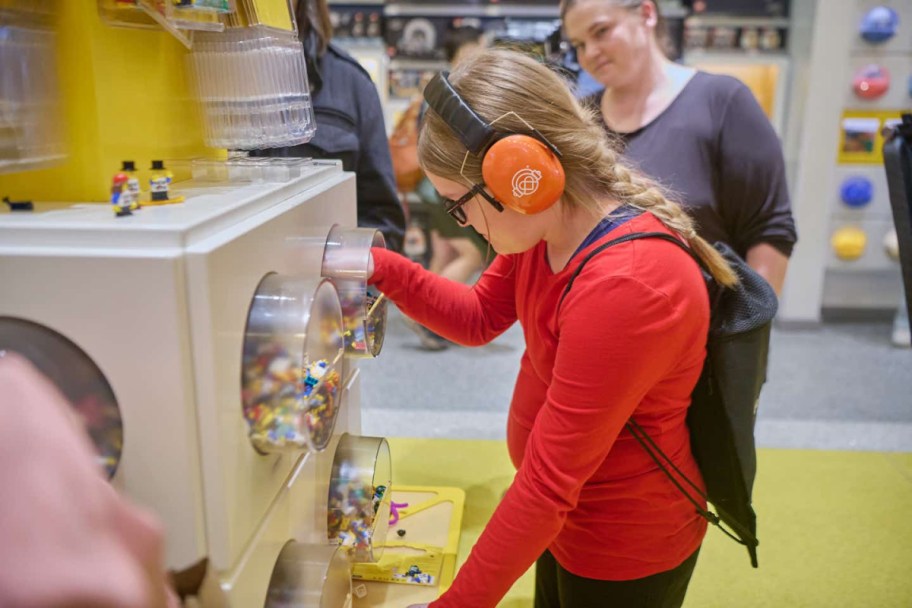 a neurodivergent LEGO patron wearing noise-reducing and sensory inclusive headphones