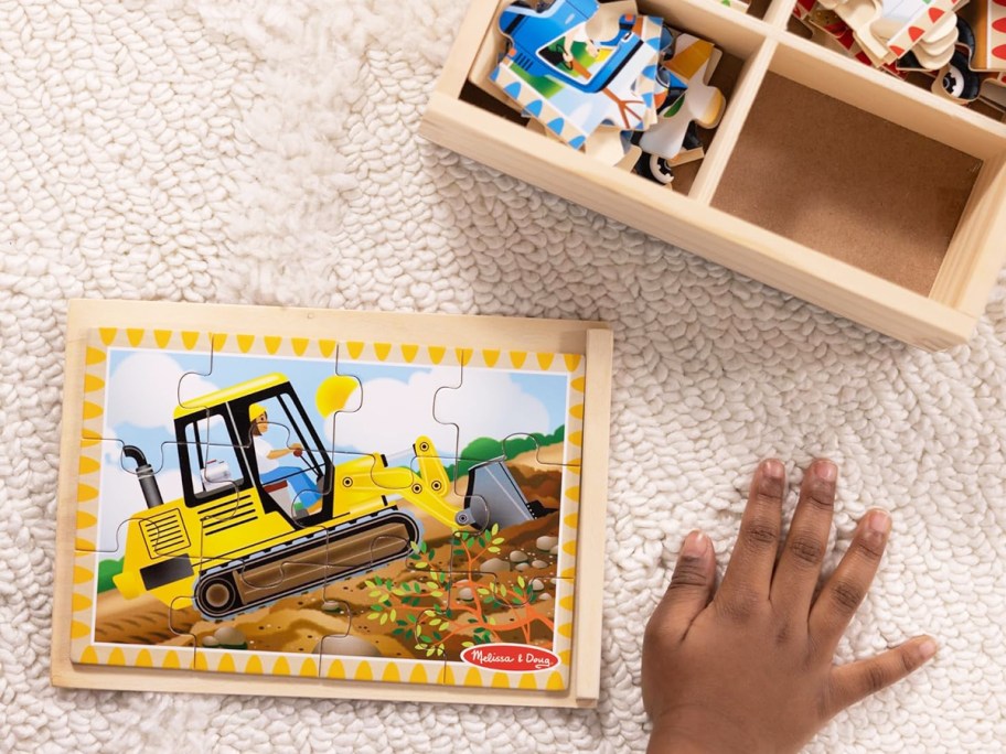 child onlinepleting a construction vehicle wooden puzzle