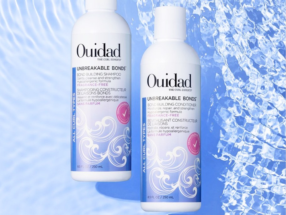 white and purple bottles of Ouidad Unbreakable Bonds shampoo and conditioner