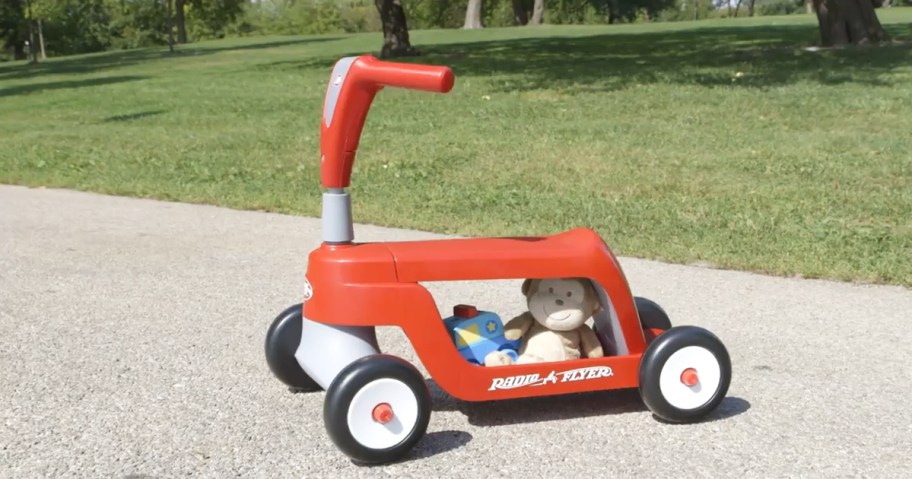 red radio flyer ride-on scooter with toys under seat