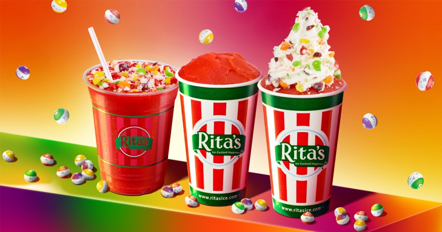 three cups of Rita's Italian Ice with Skittles toppings