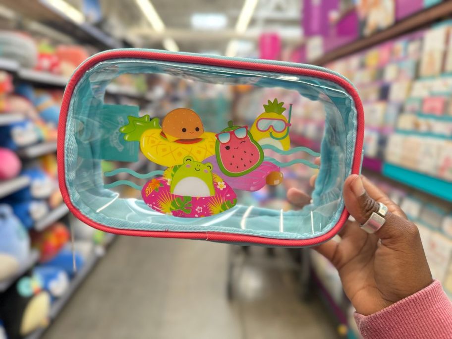 A hand holding a Squishmallows Clear Travel Bag