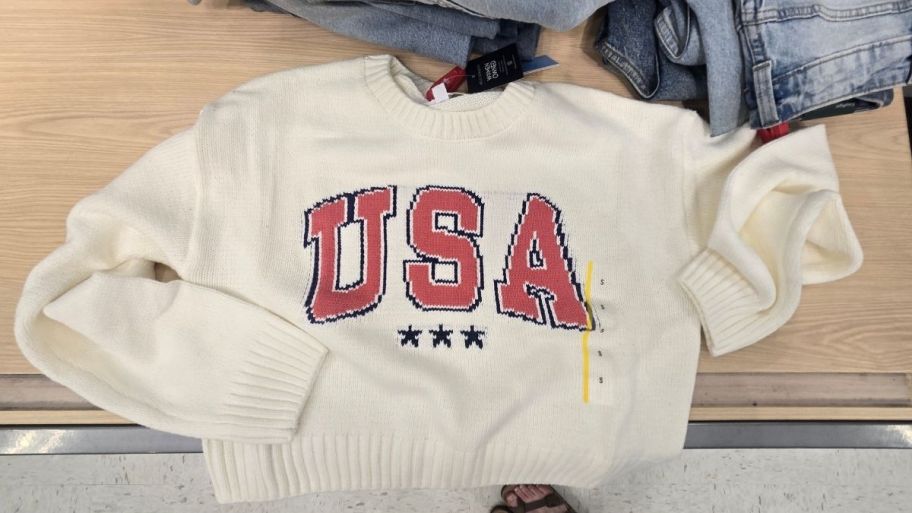 a white sweater with USA graphic on the front
