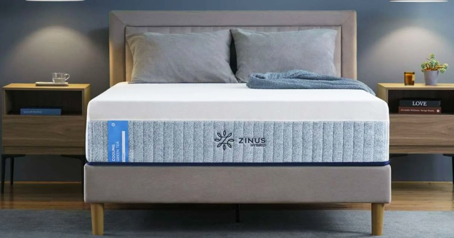 memory foam mattress with pillows on top of a grey bed frame with matching headboard