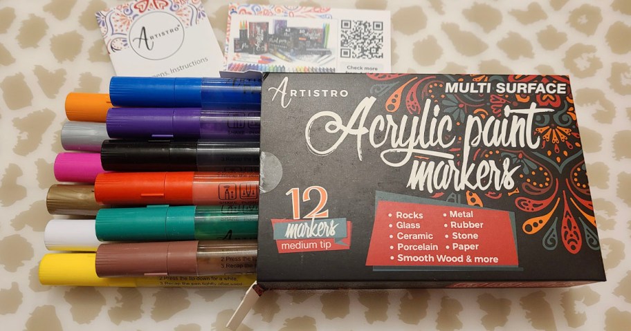 artistro arcylic paint pens box with pens onlineing out laying on table