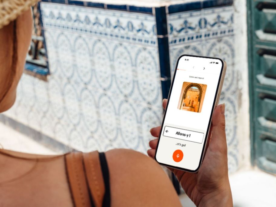 Woman looking at Babbel app on a phone