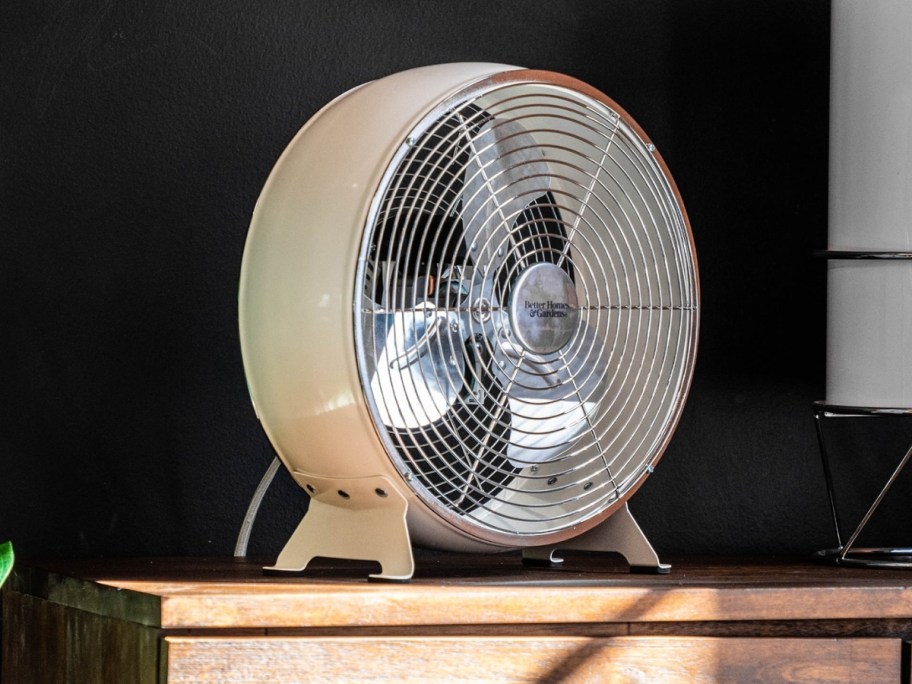 white metal round drum retro style fan on a buffet table