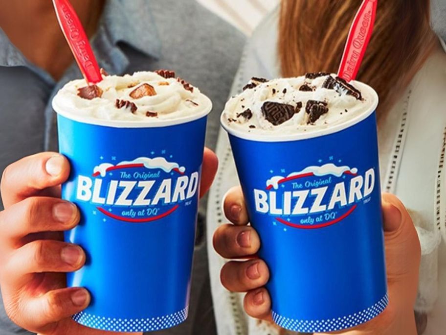 two people holding dairy queen blizzards