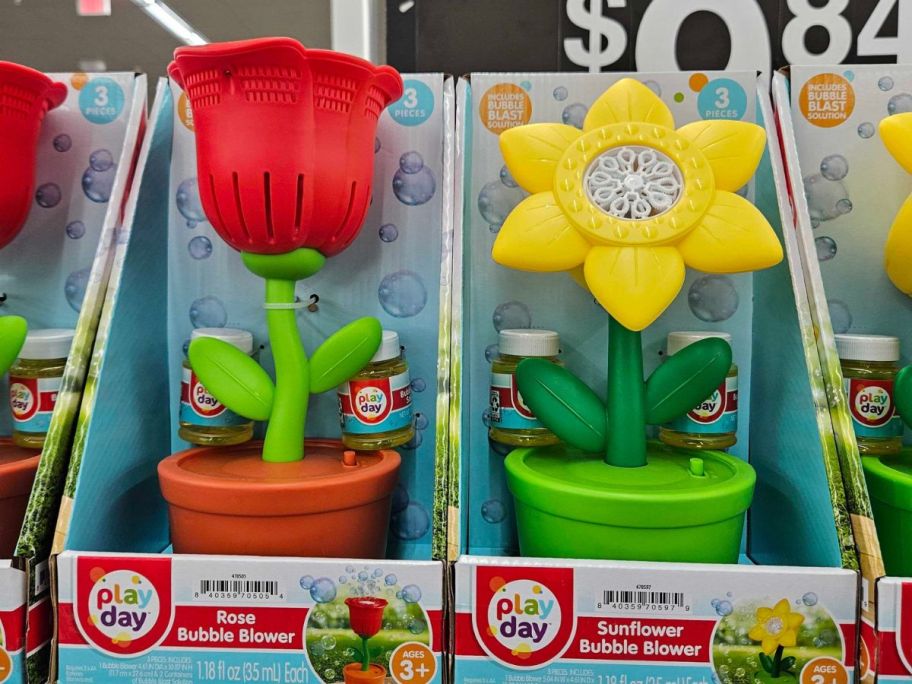 toy bubble maker machines shaped like flowers in flower pots on a shelf in store