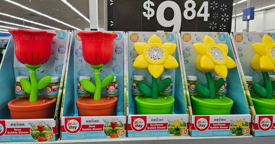 toy bubble maker machines shaped like flowers in flower pots on a shelf in store