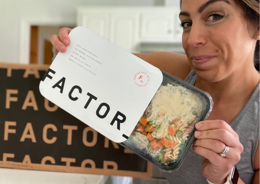 woman pulling factor meal out of package