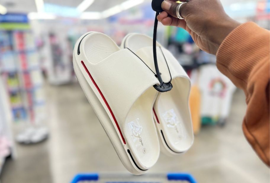 a pair of white mens slide with red and blue accents