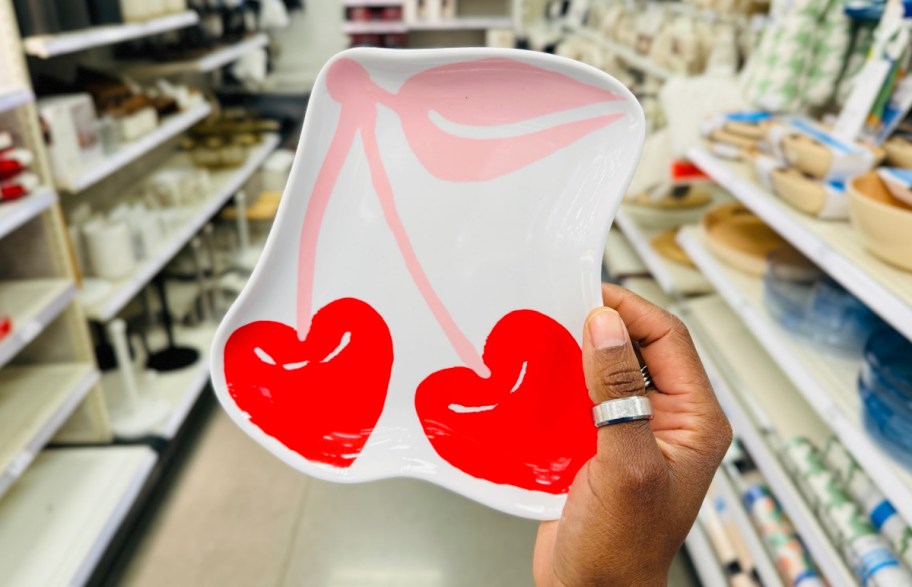 hand holding cherry plate in red and pink