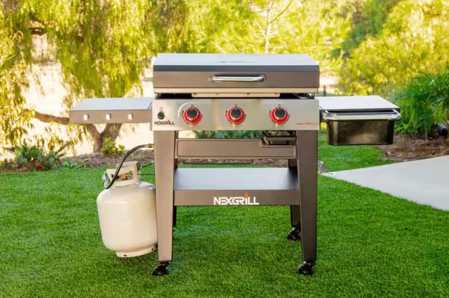 gray and black grill sitting in grass