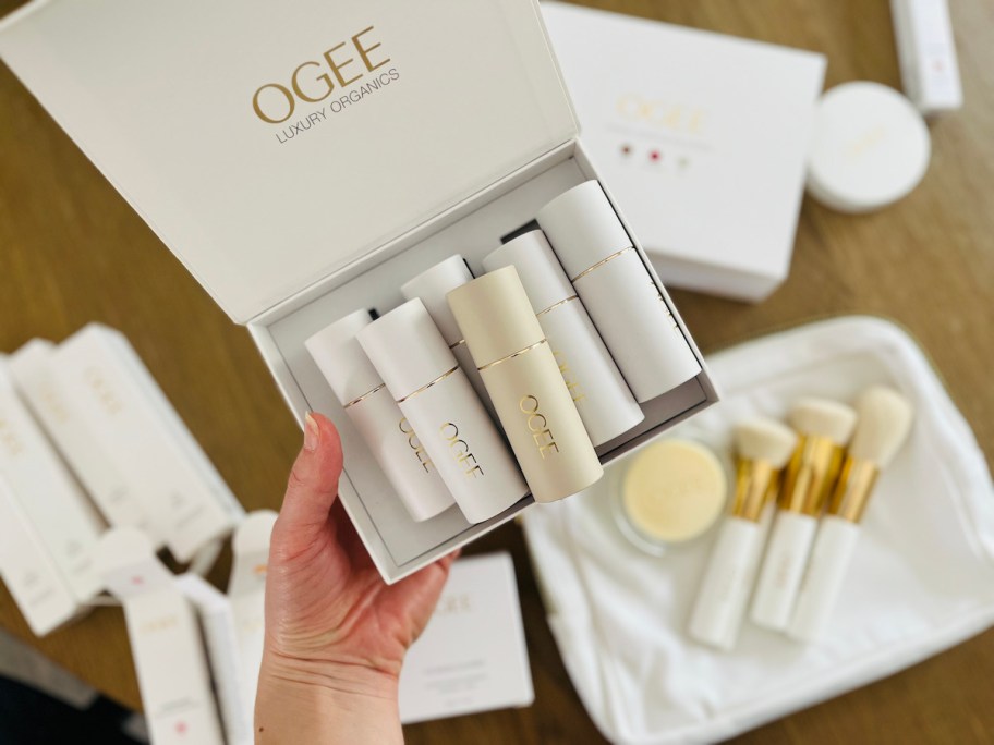 hand holding box of ogee luxury organics makeup