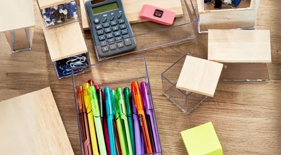 desk organizer containers on a desk top filled with various office supplies