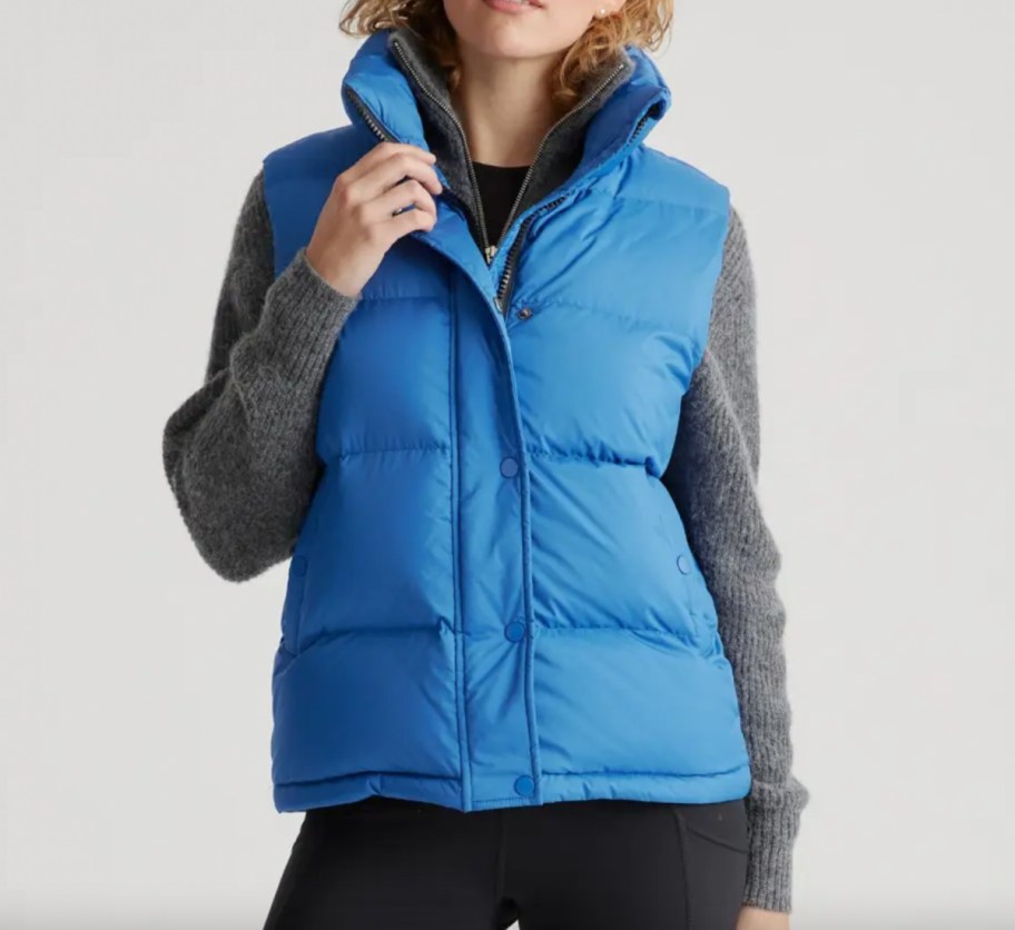 woman in blue puffer vest