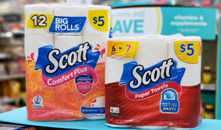 a twelve pack of scott onlinefort plus toilet paper and a 6 pack of scott paper towels on a store shelf