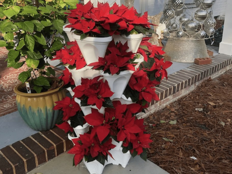 stacked planters with flowers displayed on it