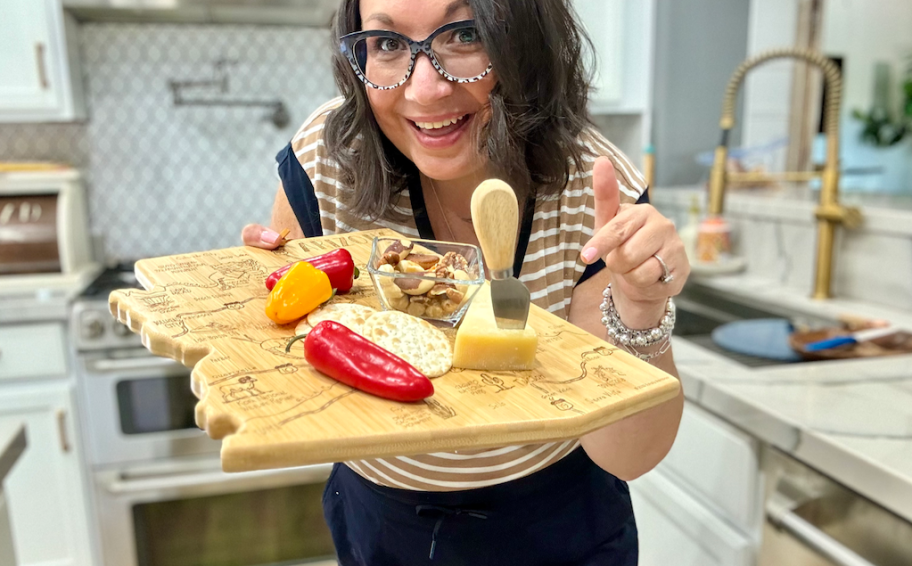 woman holding state cutting board