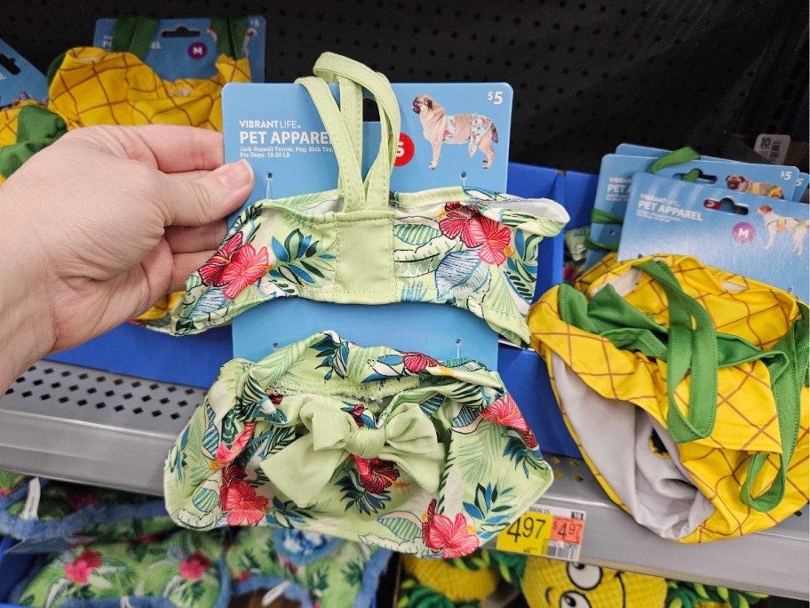 hand holding a Hawaiian print dog bikini