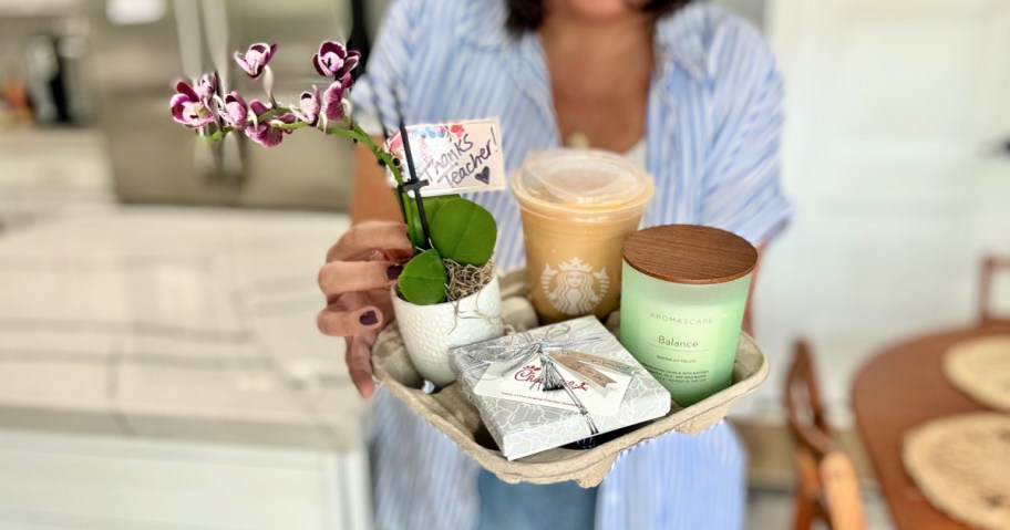 woman holding a drink holder with teacher gifts