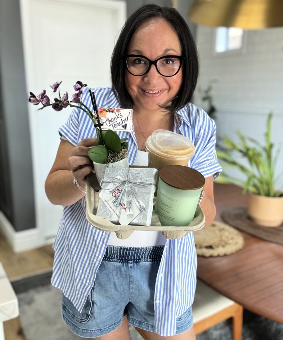 woman holding a last minute teacher appreciation gift in a drink holder 