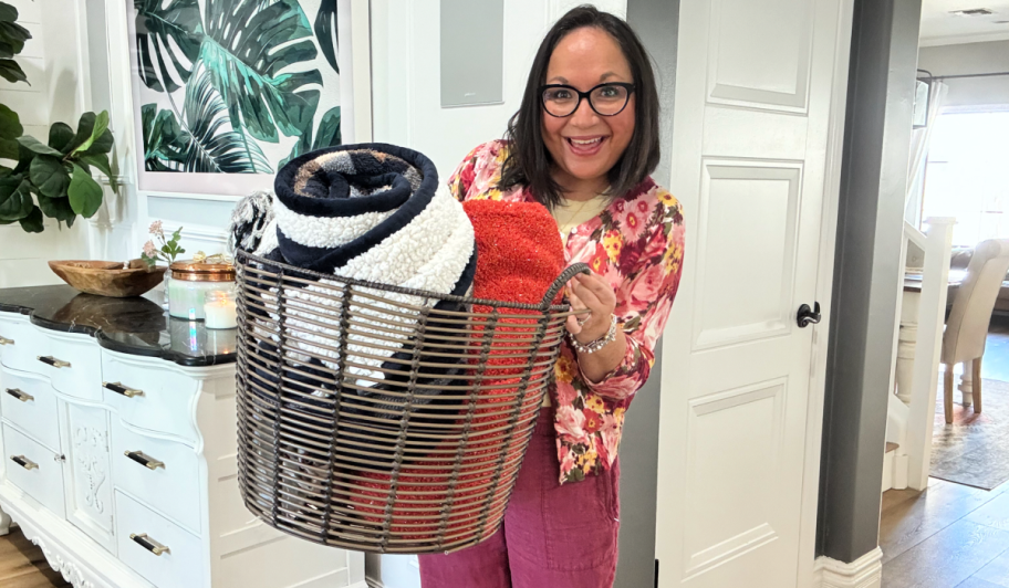 woman holding a walmart basket with blankets