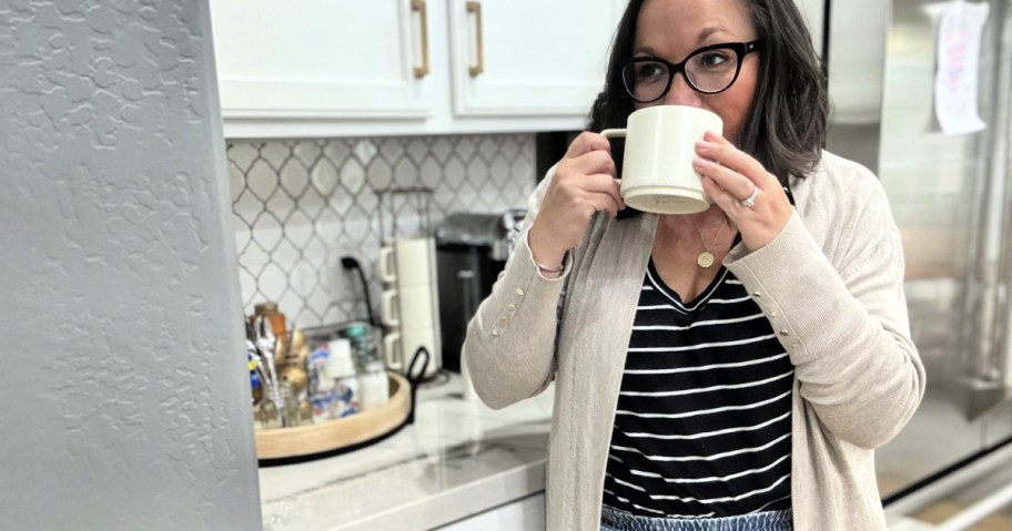 woman sipping coffee next to coffee bar station