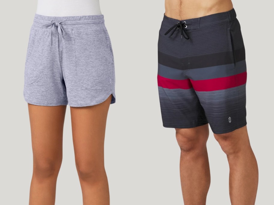 woman wearing grey knit shorts next to a man wearing black, red, and grey stripe swim board shorts