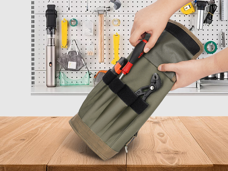 person using a roll up tool bag 