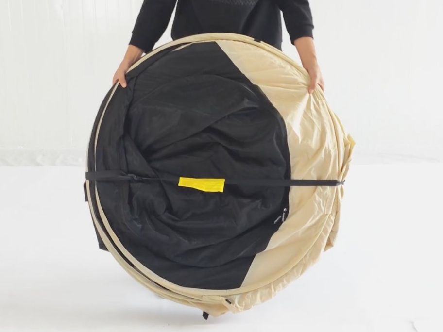 A man with an Alvantor Pop-Up Screen Tent Gazebo 10'x10' folded up