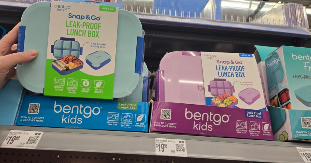 Woman grabbing blue bentgo kids lunchbox off the store shelf at Walmart