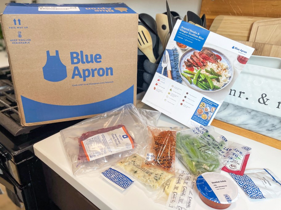 blue apron box with ingredients spread out