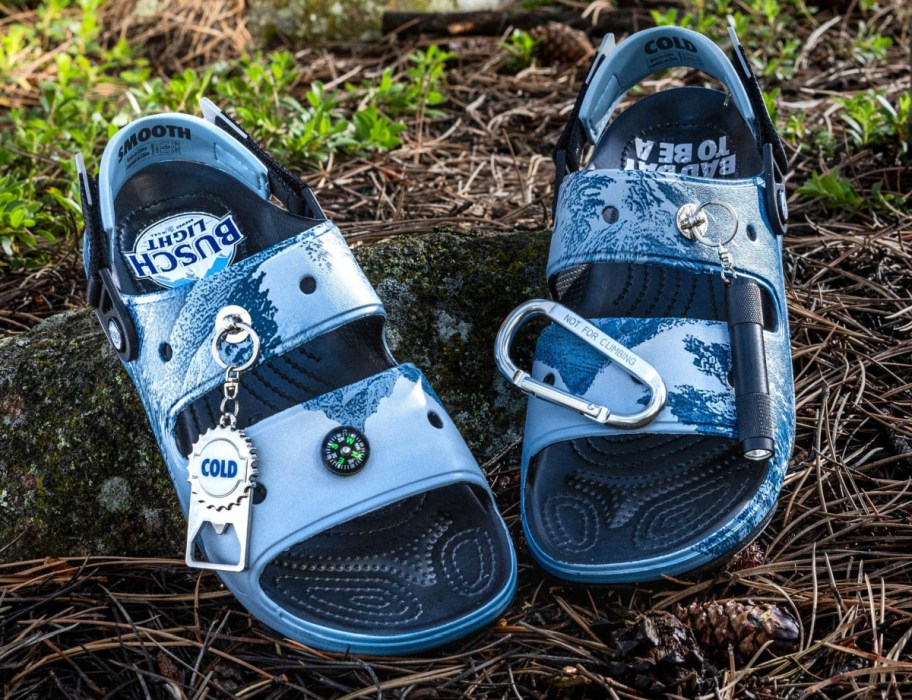 Busch Light Crocs Slides with beer opener shown outside