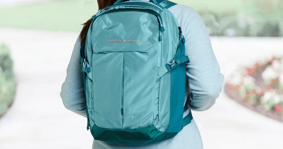 woman wearing a blue Eddie Bauer Backpack