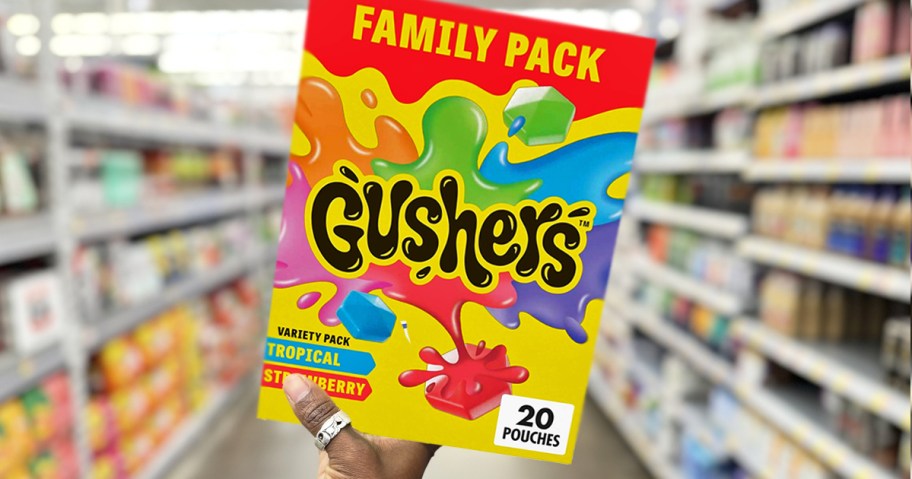 hand holding a box of gushers in store