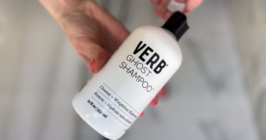 hands holding a bottle of Verb Ghost Shampoo