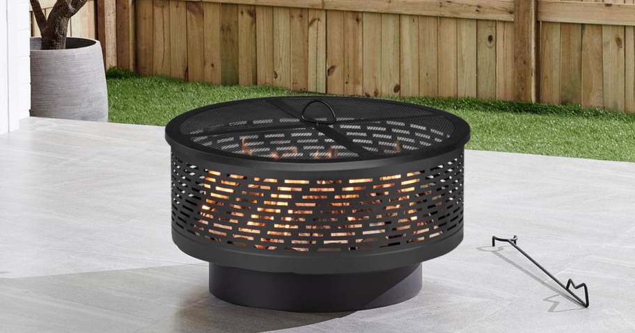 round black fire pit on patio
