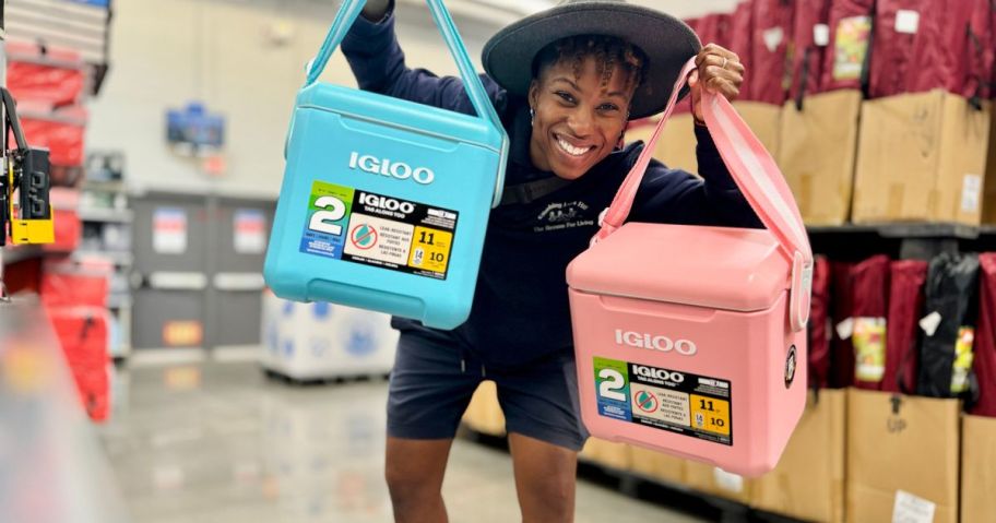 A woman holding two Igloo coolers in blue and pink