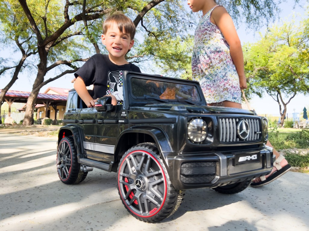 little boy in g wagon car