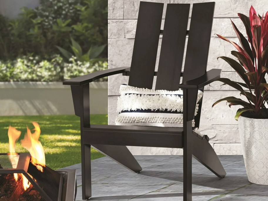 black adirondack chair with white throw pillow on patio