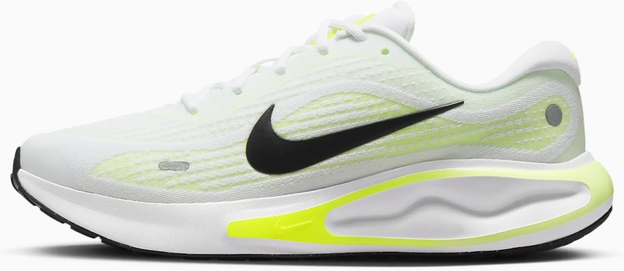 white, black, and yellow nike running shoe