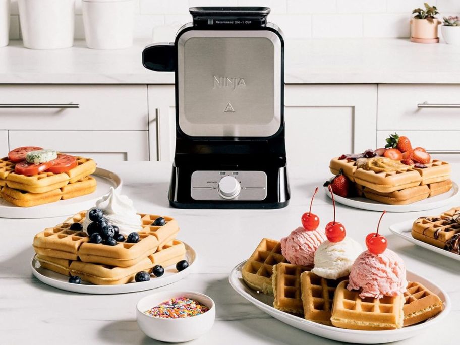 Ninja NeverStick Belgian Waffle Maker PRO surrounded by plates of waffles