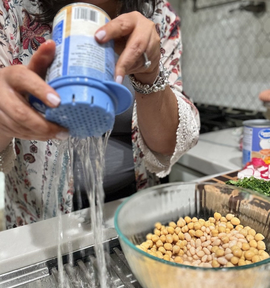 Woman using a Prepworks can colander to drain beans