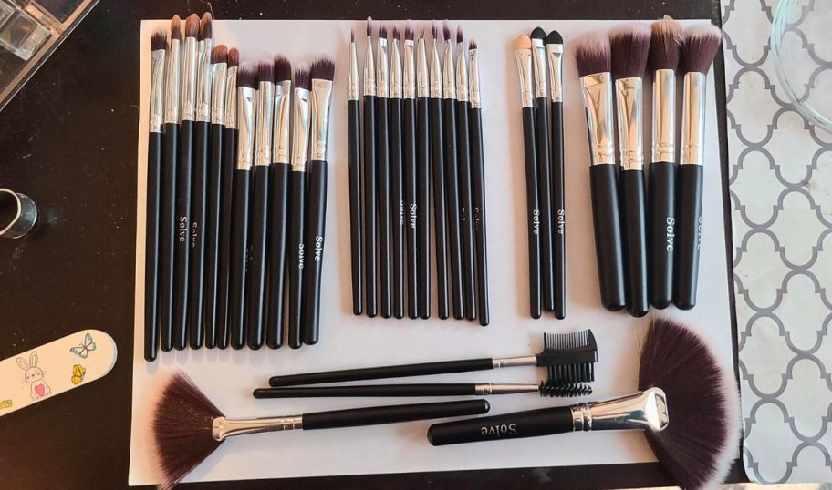 makeup brush set spread out on a counter 